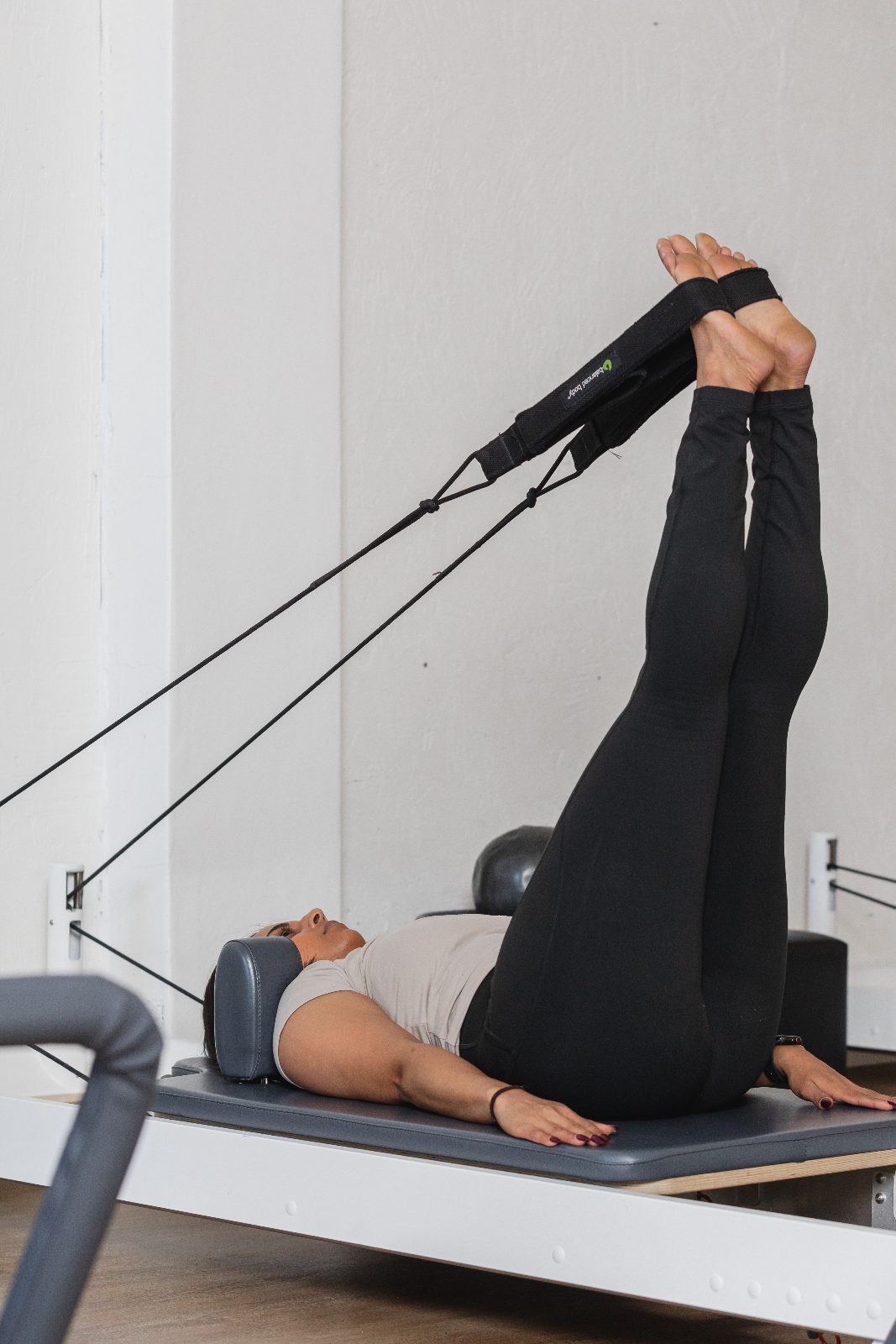 Hands on the straps of a reformer at All for One