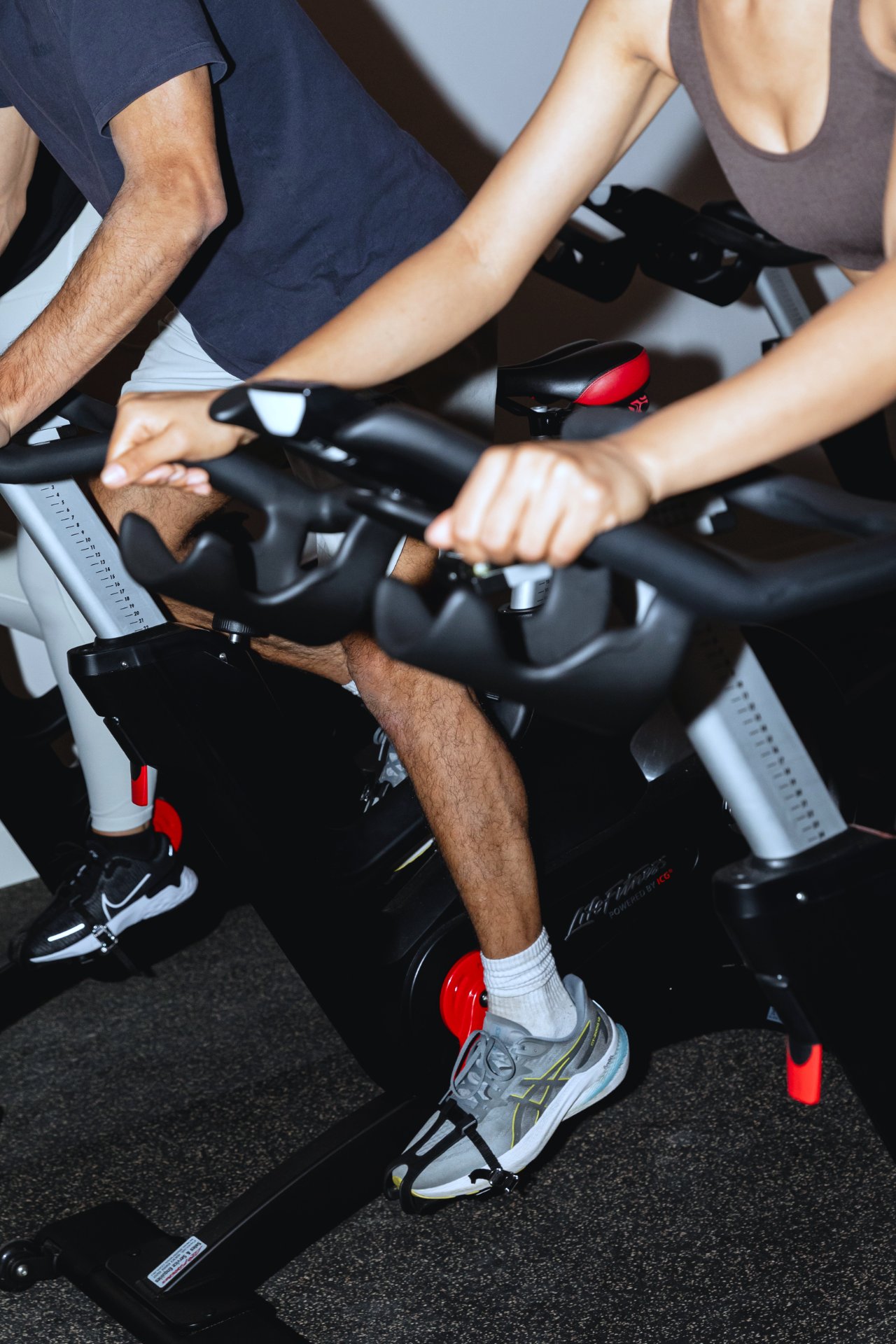 A rider mid-climb during a spin class at All for One