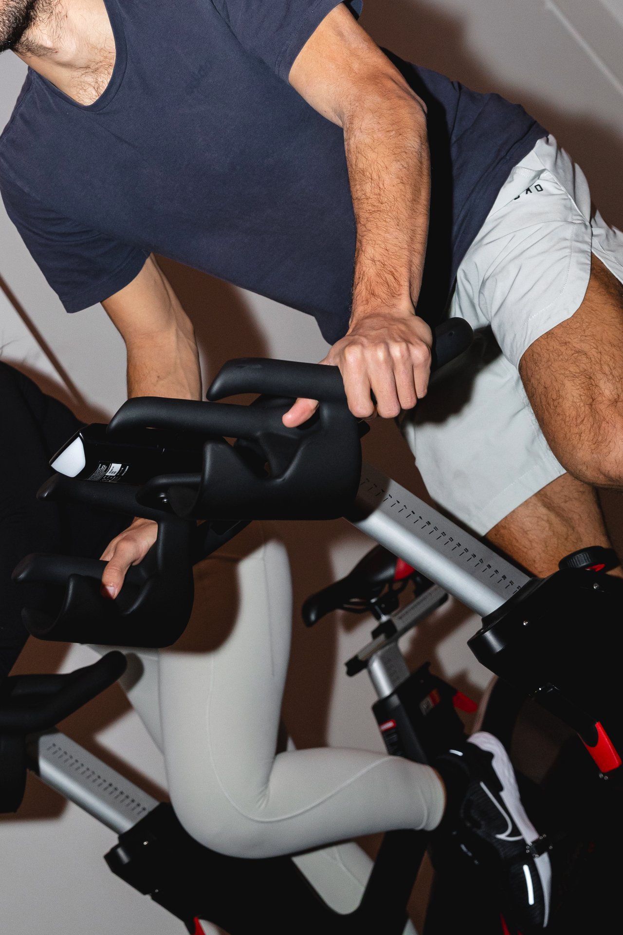 An instructor leading a spin class at All for One