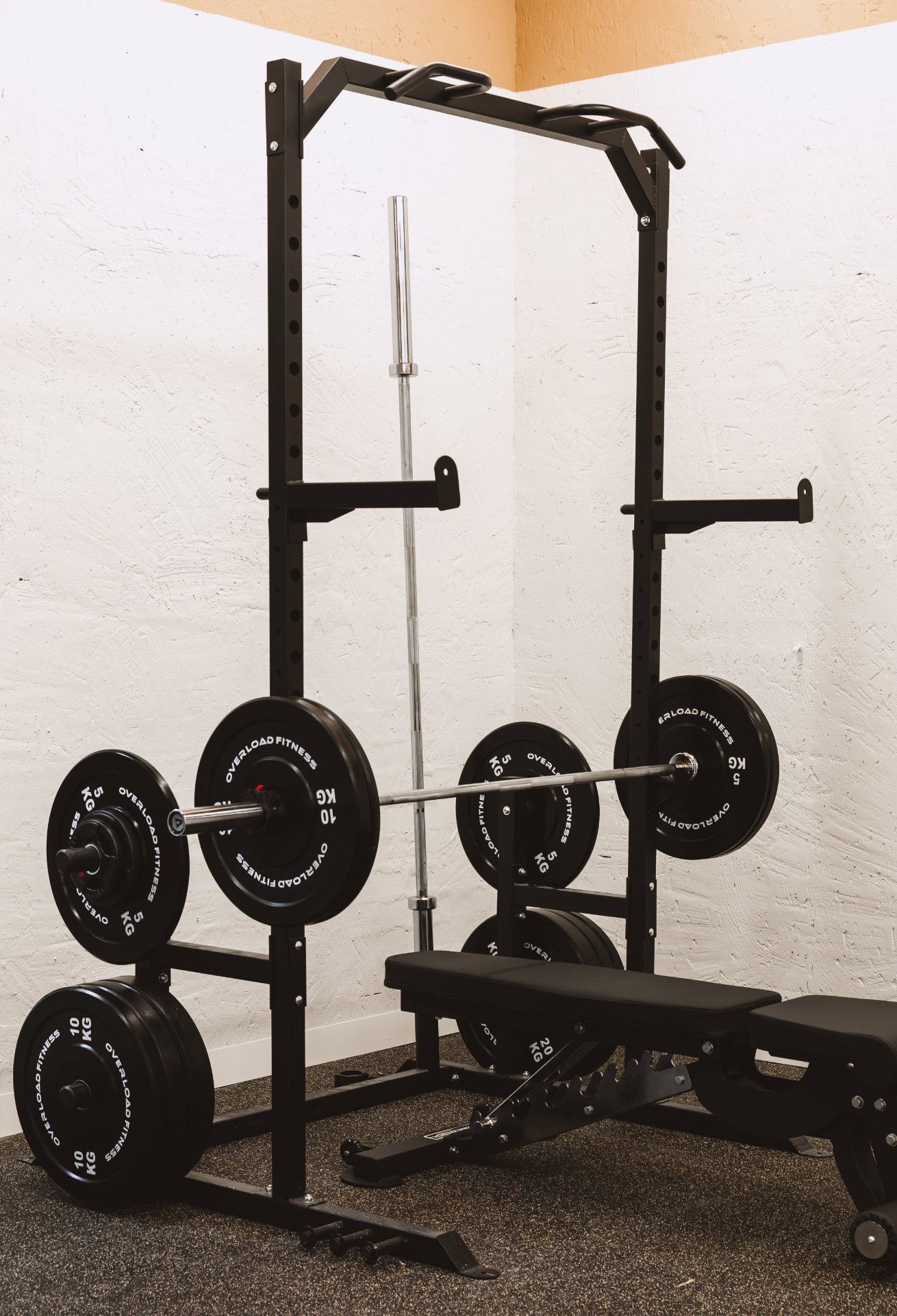 A member mid-lift with a coach nearby at All for One