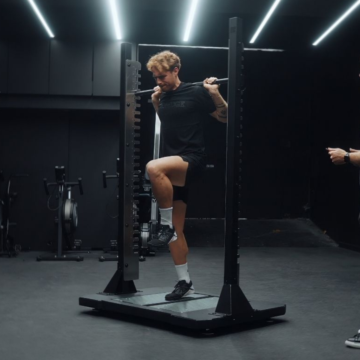 Single-leg squat test on a VALD force plate inside the testing rack